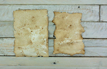 Piece of old paper on wooden planksの写真素材