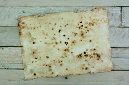 Piece of old paper on wooden planksの写真素材