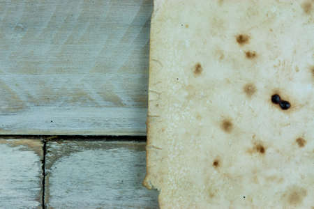 Piece of old paper on wooden planksの写真素材