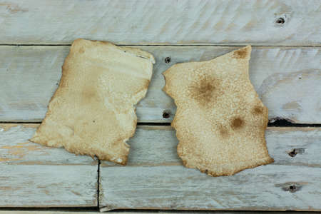 Piece of old paper on wooden planksの写真素材