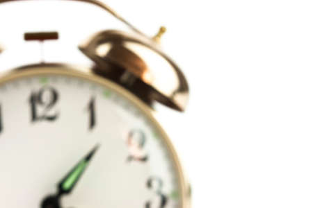 Close up of an alarm clock on a white background - blurredの写真素材