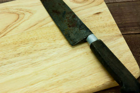 Wooden chopping board with an old knifeの写真素材
