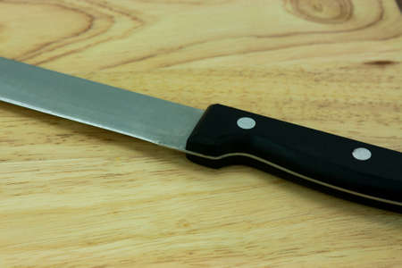 Wooden chopping board with an old knifeの写真素材