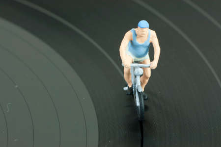 Model people having a cycle race on a record