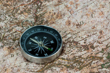 Close up of a compass on an old map