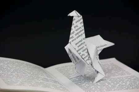 Origami dinosaur with words coming out of a book. Lorem Ipsum text used.の写真素材