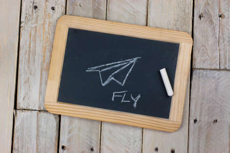 Small blackboard with chalk on a wooden backgroundの写真素材
