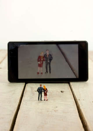 Model couple taking a selfie on a mobile phone