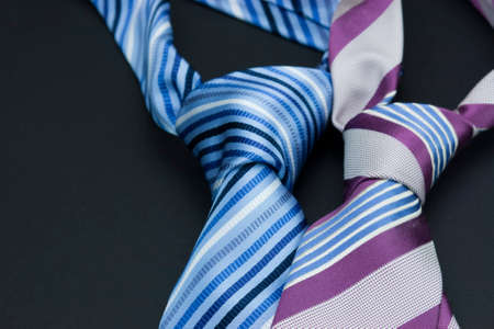 Man's neck tie laying on a black backgroundの写真素材