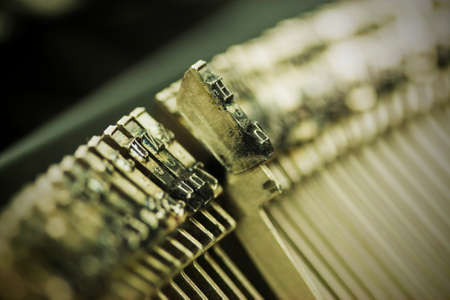 Close up of hammer keys on an old type writer. Shallow depth of field. Vintage style filter applied.の写真素材