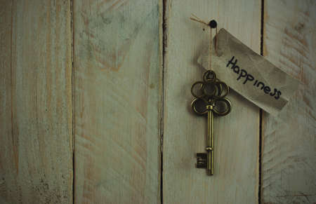 Set of old antique keys on a wooden background. Vintagefilter applied.の写真素材