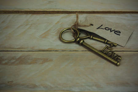 Set of old antique keys on a wooden background. Vintagefilter applied.の写真素材