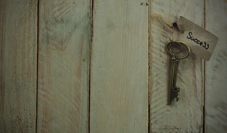 Set of old antique keys on a wooden background. Vintagefilter applied.の写真素材
