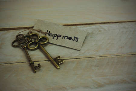 Set of old antique keys on a wooden background. Vintagefilter applied.の写真素材