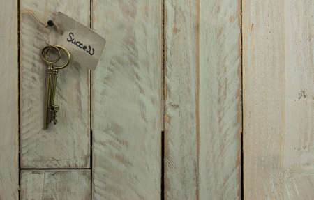 Set of old antique keys on a wooden background.