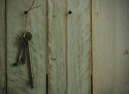Set of old antique keys on a wooden background. Vintagefilter applied.の写真素材