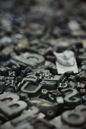 Close up of old used metal typeset letters. Vintage filter applied.の写真素材
