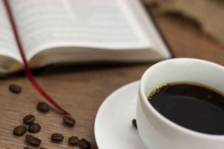 White coffee cup and saucer against a rustic backgroundの写真素材