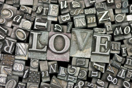 Close up of old used metal typeset letters with the word Love.の写真素材