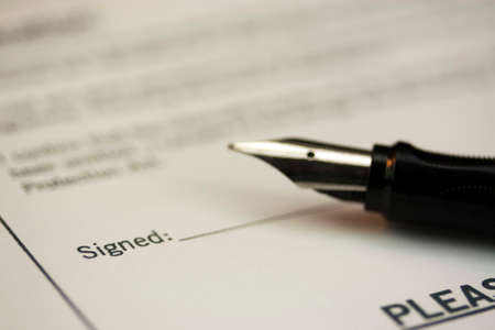 Close up of a fountain pen on a university application formの写真素材