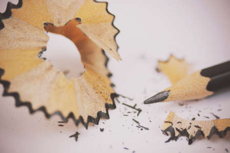 Close up of a pencil being sharpened on a light backgroundの写真素材