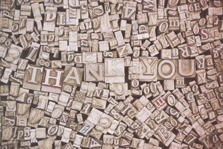 Close up of old used metal typeset letters with the words Thank You. Retro filter applied.の写真素材