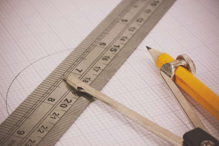 Close up of compass and ruler on graph paperの写真素材
