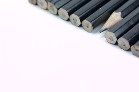 Close up of black pencils in a line on a light backgroundの写真素材