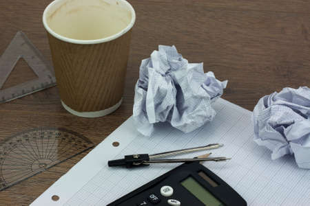 Calculator and drawing equipment and graph paper on a table