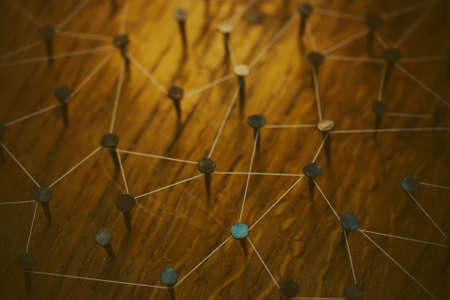 Rustic nails in wood linked together by cotton with a golden tint. Vintage filter applied.の写真素材