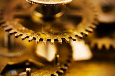 Close up of cogs from the inside of a clock. Retro filter applied.の写真素材