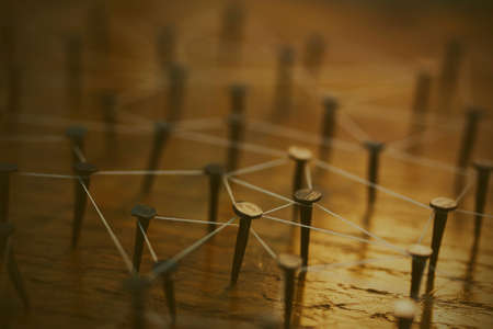 Rustic nails in wood linked together by cotton with a golden tint. Vintage filter applied.の写真素材