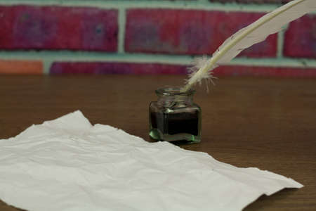 White feather quill pen with metal nib