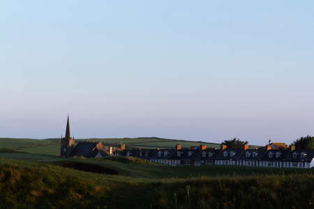 View across a golf course to the church behindの写真素材