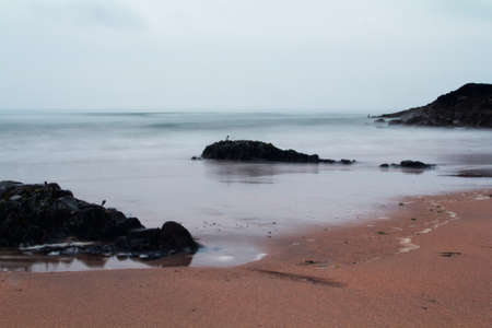 Long exposure shot of the sea coming inの写真素材
