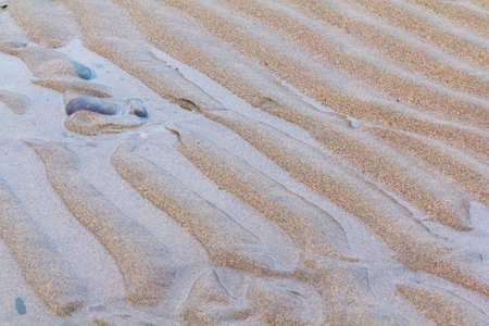 Close up of wet sand on the beach