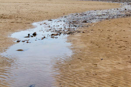 Water running over the sand on a beach