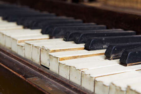 Old broken disused piano with damaged keysの写真素材