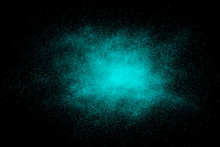 Cyan abstract powder explosion on a black backgroundの写真素材