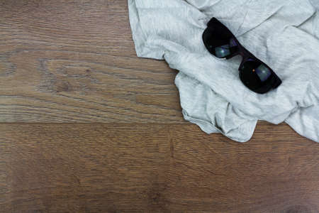 Summer essentials laying on a wooden floorの写真素材
