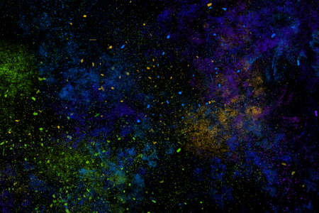 Colourful abstract powder explosion on a black background