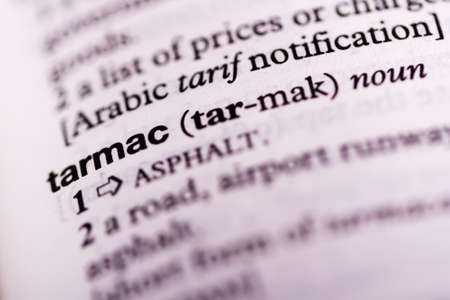 Blurred close up of the dictionary definition of tarmac