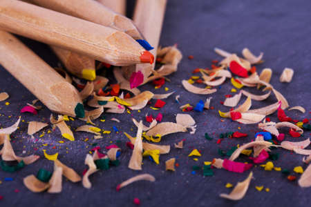 Close-up of coloured pencils on a worn black backgroundの写真素材