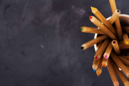 Close up of coloured pencils on a worn black backgroundの写真素材