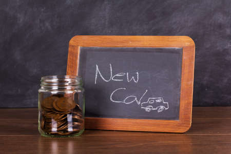 Glass jar with a blackboard on wooden surfaceの写真素材