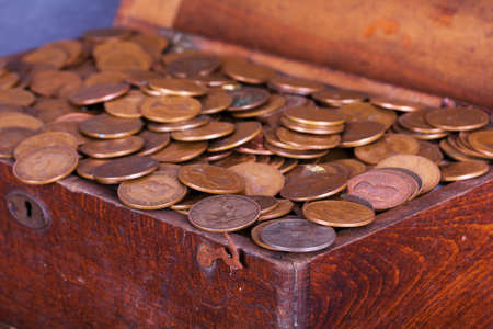 Old wooden chest filled with old copper coins