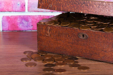 Old wooden chest filled with old copper coins