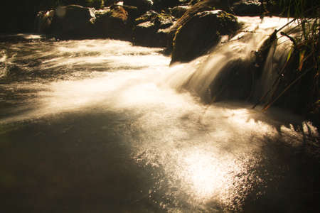Long exposure shot of a waterfall in a small country stream.の写真素材