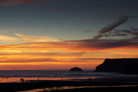Colourful sunset over the beach at Polzeath, Cornwallの写真素材