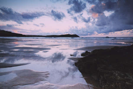 Early morning view of the beach at Polzeath, England Vintage Retro Filter.